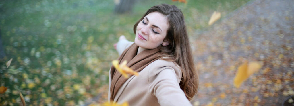 smiling woman with eyes closed